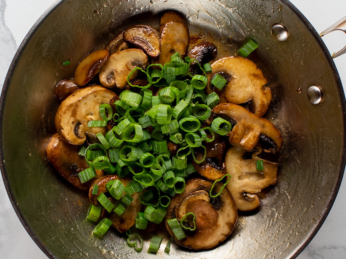 Cooked Baby Bella Mushrooms & Scallions in Skillet